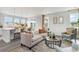 Bright, open-concept living area showcasing a modern kitchen island with barstool seating and cozy sofa at 1813 Brook Park Pl., Conway, SC 29526