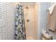 Shower with neutral tile, striking geometric wallpaper, and a colorful shower curtain at 1819 Martin Circle, Myrtle Beach, SC 29579