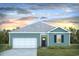 Charming single-story home with blue siding, a grey roof, a one-car garage and a well-manicured front lawn at 200 Jeff Waters Circle, Longs, SC 29568