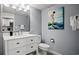 Bathroom featuring a modern vanity, toilet, mirror and beach themed art at 2000 N Ocean Blvd. # 1509, Myrtle Beach, SC 29577