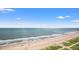 Beautiful ocean view of the beach with blue skies and people walking along the beach at 2000 N Ocean Blvd. # 1509, Myrtle Beach, SC 29577