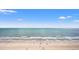 Beautiful ocean view of the beach with blue skies and people walking along the beach at 2000 N Ocean Blvd. # 1509, Myrtle Beach, SC 29577