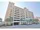 Camelot By The Sea resort featuring multi-level parking, palm trees, and lovely landscaping at 2000 N Ocean Blvd. # 1509, Myrtle Beach, SC 29577