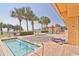 Outdoor pool and jacuzzi area with palm trees, a nearby beach, and lounge seating at 2000 N Ocean Blvd. # 1509, Myrtle Beach, SC 29577
