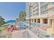 A resort pool featuring lounge chairs, picnic tables, and palm trees with beach access at 2000 N Ocean Blvd. # 1509, Myrtle Beach, SC 29577