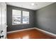 Bedroom featuring hardwood floors, two windows with blinds, and stylish gray walls at 2049 Oxford St., Myrtle Beach, SC 29577
