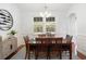 Bright dining room with modern chandelier and large windows overlooking lush greenery at 2049 Oxford St., Myrtle Beach, SC 29577