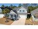 Two-story home with well-manicured lawn, two-car garage, and front porch at 2049 Oxford St., Myrtle Beach, SC 29577