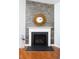 Elegant fireplace with stone accents and a decorative mirror adding warmth and charm to the living room at 2049 Oxford St., Myrtle Beach, SC 29577