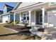 Inviting front porch featuring a seating area, landscaping, and a walkway to the home's entrance at 2049 Oxford St., Myrtle Beach, SC 29577