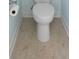 Close-up of a toilet showing the beige tile flooring and light blue wall color at 2049 Oxford St., Myrtle Beach, SC 29577