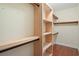 Spacious walk-in closet with built-in wooden shelves and hanging rods for organized storage at 2049 Oxford St., Myrtle Beach, SC 29577