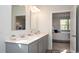 Elegant bathroom with dual sinks, quartz countertop, and bedroom access at 212 Jeff Waters Circle, Longs, SC 29568