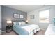 Cozy bedroom featuring a stylish accent wall, comfortable bed, and natural light from the window at 212 Jeff Waters Circle, Longs, SC 29568