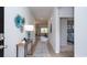 Inviting hallway with decor, leading to living area and bedroom with neutral walls and wood-look floors at 212 Jeff Waters Circle, Longs, SC 29568