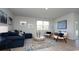 Bright living room with comfortable seating, neutral walls, and view of the outdoor space at 212 Jeff Waters Circle, Longs, SC 29568