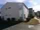 Exterior view of a two-story home with neutral siding, manicured shrubs, and an inviting facade at 2257 Huntingdon Dr. # F, Surfside Beach, SC 29575