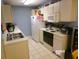 Functional kitchen featuring white cabinetry and appliances, and a double sink at 2257 Huntingdon Dr. # F, Surfside Beach, SC 29575