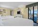 Bright bedroom featuring two queen beds, a dresser with a TV, and a balcony overlooking the ocean at 2311 S Ocean Blvd. # 771, Myrtle Beach, SC 29577