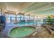 Spacious indoor pool area featuring a hot tub, large windows, and ample seating at 2311 S Ocean Blvd. # 771, Myrtle Beach, SC 29577