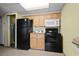 A functional kitchen featuring wood cabinets and modern black appliances, creating a cozy cooking space at 2311 S Ocean Blvd. # 771, Myrtle Beach, SC 29577