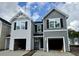 New construction townhomes with gray siding and a one car garage under a cloudy blue sky at 262 Christiana Ln. # A, Myrtle Beach, SC 29579