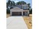 New two-story home with modern gray siding, a spacious two-car garage, and a concrete driveway at 264 Warner Crossing Way, Loris, SC 29569