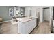 Open kitchen with granite island, stainless steel appliances, white cabinets, and dining area at 264 Warner Crossing Way, Loris, SC 29569