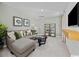 Cozy living room with a comfortable sectional, large-screen TV, stylish decor, and soft lighting at 264 Warner Crossing Way, Loris, SC 29569
