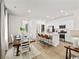 Open floor plan integrating kitchen, dining area, and living room with natural light and modern decor at 264 Warner Crossing Way, Loris, SC 29569