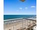 Breathtaking beach view from this building's balcony with chairs and a small table at 2701 N Ocean Blvd. # 1857/1860, Myrtle Beach, SC 29577