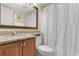 Well-lit bathroom features a granite vanity, toilet, and shower with curtain at 2701 N Ocean Blvd. # 1857/1860, Myrtle Beach, SC 29577