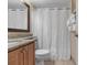 Well-lit bathroom features a granite vanity, toilet, and shower with curtain at 2701 N Ocean Blvd. # 1857/1860, Myrtle Beach, SC 29577