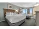 Bright bedroom with two beds, seascape artwork and a bay window at 2701 N Ocean Blvd. # 1857/1860, Myrtle Beach, SC 29577