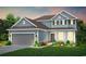 Charming two-story home showcasing a light blue exterior, well-manicured lawn, and an attached two-car garage at 291 River Edge Dr., Myrtle Beach, SC 29588