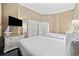 Serene bedroom with two beds, a dresser with a TV, and ample closet space at 300 N Ocean Blvd. # 324, North Myrtle Beach, SC 29582