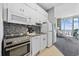 Efficient white kitchen with appliances and access to an ocean view and living area at 300 N Ocean Blvd. # 324, North Myrtle Beach, SC 29582