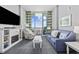 Well-lit living room featuring stylish sofa, recliner, and ocean view balcony access at 300 N Ocean Blvd. # 324, North Myrtle Beach, SC 29582