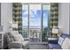 Bright living room featuring stylish furnishings, a cozy recliner, and balcony access with ocean views at 300 N Ocean Blvd. # 324, North Myrtle Beach, SC 29582