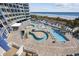 Aerial view of the pool deck with a lazy river, lounge chairs, and beach views in the background at 300 N Ocean Blvd. # 324, North Myrtle Beach, SC 29582