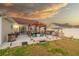 Spacious backyard with a pergola-covered seating area, a hot tub, and an outdoor kitchen with a built-in grill at 304 Carolina Springs Ct., Conway, SC 29527
