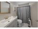 Well-lit bathroom with a modern vanity, neutral color scheme, and a shower featuring a decorative curtain at 304 Carolina Springs Ct., Conway, SC 29527