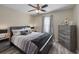 Comfortable bedroom with a ceiling fan, gray color scheme, and natural light creating a serene atmosphere at 304 Carolina Springs Ct., Conway, SC 29527