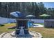 Backyard fireplace with Buddha statue offering a cozy atmosphere for outdoor gatherings at 304 Carolina Springs Ct., Conway, SC 29527
