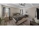 Elegant main bedroom with tray ceiling, hardwood floors, and ample natural light at 304 Carolina Springs Ct., Conway, SC 29527