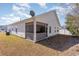 A view of the backyard featuring a screened-in porch and vinyl siding at 321 Cabo Loop, Myrtle Beach, SC 29588