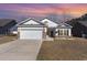 Charming single Gathering home with a two-car garage and a cozy front lawn at 321 Cabo Loop, Myrtle Beach, SC 29588