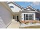 Welcoming front porch with brick accents, decorative barrels, and black shutters at 321 Cabo Loop, Myrtle Beach, SC 29588