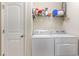 Laundry room with a white door and white washer and dryer units at 321 Cabo Loop, Myrtle Beach, SC 29588