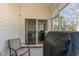 Covered patio featuring sliding glass doors, seating, and a grill, perfect for outdoor relaxation at 321 Cabo Loop, Myrtle Beach, SC 29588